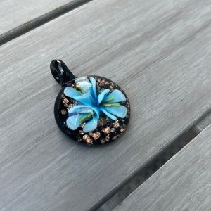 Glass pendant with beautiful blue flower